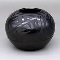 A black-on-black bowl decorated with a three-panel geometric design
 by Minnie Vigil of Santa Clara