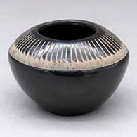 A small black bowl decorated with a sgraffito ring-of-feathers design above the shoulder
 by Andrew and Judy Harvier of Santa Clara