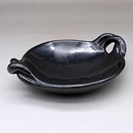 A polished black serving plate with twisted handles, click or tap to see a larger version