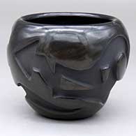 A black jar decorated with an avanyu design carved into the body
 by Madeline Naranjo of Santa Clara