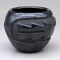 A black bowl carved with a stylized avanyu and geometric design
 by Gracie Naranjo of Santa Clara