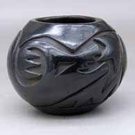 A black jar carved around the body with a plumed avanyu and geometric design
 by Reycita Cosen of Santa Clara