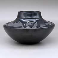 A high-shoulder black jar with a three-panel geometric design carved above the shoulder, click or tap to see a larger version