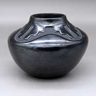 A black, high-shouldered jar decorated with a four-panel kiva step and geometric design above the shoulder, click or tap to see a larger version