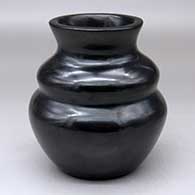 A plain, polished black double-shoulder jar with a flared rim
 by Susan Roller of Santa Clara