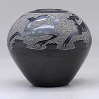 A black seed pot decorated with a sgraffito deer and geometric design above the shoulder, click or tap to see a larger version