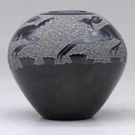 A black seed pot decorated with a sgraffito deer and geometric design above the shoulder, click or tap to see a larger version