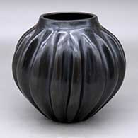 A black melon jar with 16 repousse ribs
 by Sarah Ayla Tafoya of Santa Clara