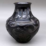 A black jar with a recurved neck and decorated with a carved avanyu, feather and geometric design
 by Sharon Naranjo Garcia of Santa Clara