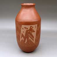 A red cylinder with a recurved neck and a sgraffito design of Fire is transformer of energy, coyote is the keeper
 by Unknown of Santa Clara