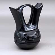 A black wedding vase carved around the body with an avanyu design
 by Frances Naranjo of Santa Clara