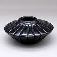 A black melon jar carved with 24 ribs
 by Anita Suazo of Santa Clara