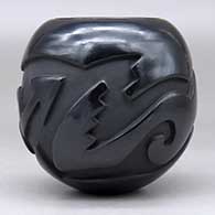 A black jar carved around the body with an avanyu design, click or tap to see a larger version