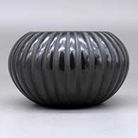 A black melon bowl carved with 32 ribs, click or tap to see a larger version
