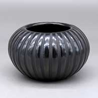 A black melon bowl carved with 32 ribs
 by Angela Baca of Santa Clara