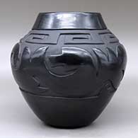 A black on black jar carved with an avanyu, scroll and geometric design, Second Prize ribbon from the Gallup InterTribal Ceremonial, click or tap to see a larger version