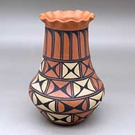 A polychrome vase with a pie crust rim and decorated around the body with a geometric design
 by Geraldine Lovato of San Felipe