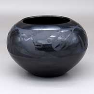 A black-on-black bowl decorated with an avanyu and geometric design above the shoulder
 by Maria Martinez of San Ildefonso