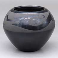 A black-on-black bowl decorated with an avanyu design above the shoulder
 by Helen Gutierrez of San Ildefonso