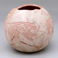 A polychrome jar with an organic opening and decorated with a four-panel fish-and-bear design and with an inlaid stone in a bear design on the bottom
 by Russell Sanchez of San Ildefonso