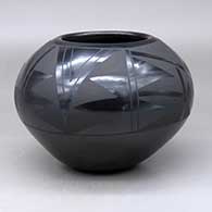 A black on black jar decorated around and above the shoulder with a two-panel geometric design
 by Santanita Suazo of Santa Clara