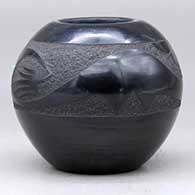 A black bowl decorated with an inlaid stone and a sgraffito plumed avanyu, cloud formation and geometric design , click or tap to see a larger version