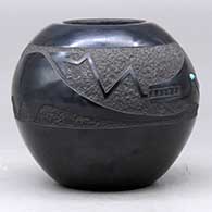 A black bowl decorated with an inlaid stone and a sgraffito plumed avanyu, cloud formation and geometric design , click or tap to see a larger version