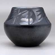 A black on black bowl decorated with a four-panel geometric design above the shoulder, click or tap to see a larger version