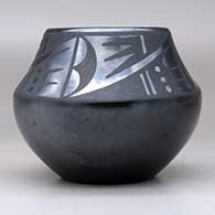 A black on black bowl decorated with a four-panel geometric design above the shoulder, click or tap to see a larger version