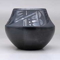 A black on black bowl decorated with a four-panel geometric design above the shoulder, click or tap to see a larger version