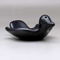 A black bird bowl with a geometric design on the inside, click or tap to see a larger version