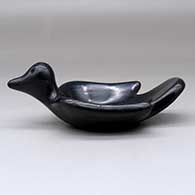 A black bird bowl with a geometric design on the inside, click or tap to see a larger version