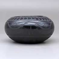 A black on black bowl decorated around the body with a plumed avanyu, ring of feathers, cloud formation and geometric design, click or tap to see a larger version