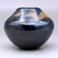 A black jar with sienna spots and inlaid stones, decorated above the shoulder with a sgraffito avanyu, feather, fineline and geometric design, click or tap to see a larger version