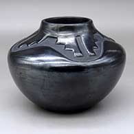 A black, high-shouldered jar decorated with a four-panel kiva step and geometric design above the shoulder
 by Juanita Pena of San Ildefonso