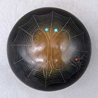 Click for a larger view A black seed pot with sienna spots, inlaid stones and a sgraffito moth, spider, spider web and geometric design
by Barbara Gonzales of San Ildefonso