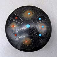 A black seed pot with sienna spots, inlaid stones and a sgraffito bird, deer, feather and geometric design
 by Barbara Gonzales of San Ildefonso