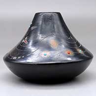 A low shouldered black jar with a sienna rim and spots, inlaid stones and decorated with a sgraffito avanyu, feather, spider, butterfly and geometric design, click or tap to see a larger version