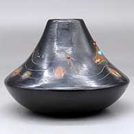 A low shouldered black jar with a sienna rim and spots, inlaid stones and decorated with a sgraffito avanyu, feather, spider, butterfly and geometric design, click or tap to see a larger version