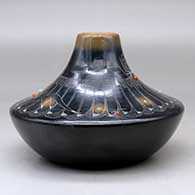 A low shouldered black jar with a sienna rim and spots, inlaid stones and decorated with a sgraffito avanyu, feather, spider and geometric design, click or tap to see a larger version