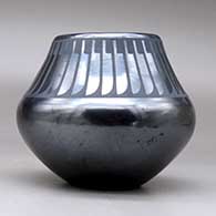 A black on gunmetal black jar decorated with a ring of feathers design above the shoulder, click or tap to see a larger version