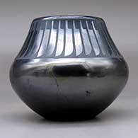 A black on gunmetal black jar decorated with a ring of feathers design above the shoulder, click or tap to see a larger version