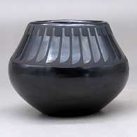 A black on black jar decorated with a ring of feathers design above the shoulder, click or tap to see a larger version