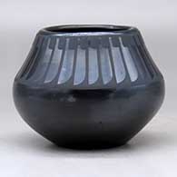 A black on black jar decorated with a ring of feathers design above the shoulder, click or tap to see a larger version