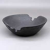 A shallow black on black bowl with a kiva step cut rim, micaceous black inside and geometric design outside
 by Cynthia Star Flower of San Ildefonso