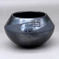 A black on black bowl decorated with a geometric design above the shoulder
 by Maximiliana Montoya of San Ildefonso