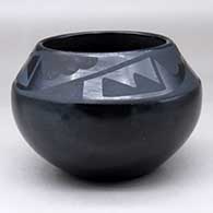 Click for a larger view A black on black jar decorated with a four panel geometric design above the shoulder
 by Maria Martinez of San Ildefonso