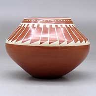 A buff on red bowl decorated with a ring of feathers design above the shoulder, click or tap to see a larger version