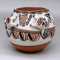 A polychrome bowl decorated with four frog appliques and a geometric design around the body
 by Lorencita Pino of Tesuque