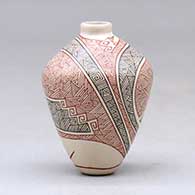 A miniature polychrome jar decorated with a fineline geometric design, click or tap to see a larger version